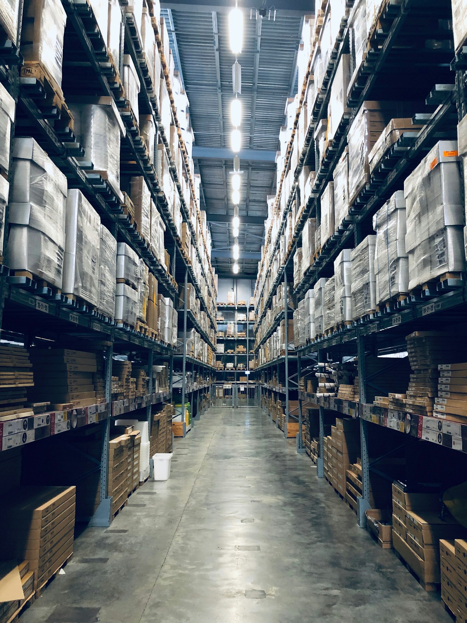 Operator reviewing inventory on a handheld device in a warehouse